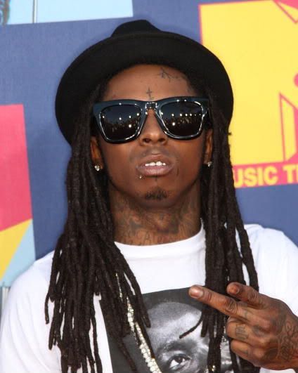 lil wayne piercings pictures. Lil' Wayne has a lip and eyebrow piercing but it's no homo because he's a 