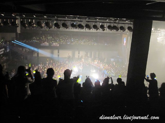 Image result for people standing in the seating at a concert